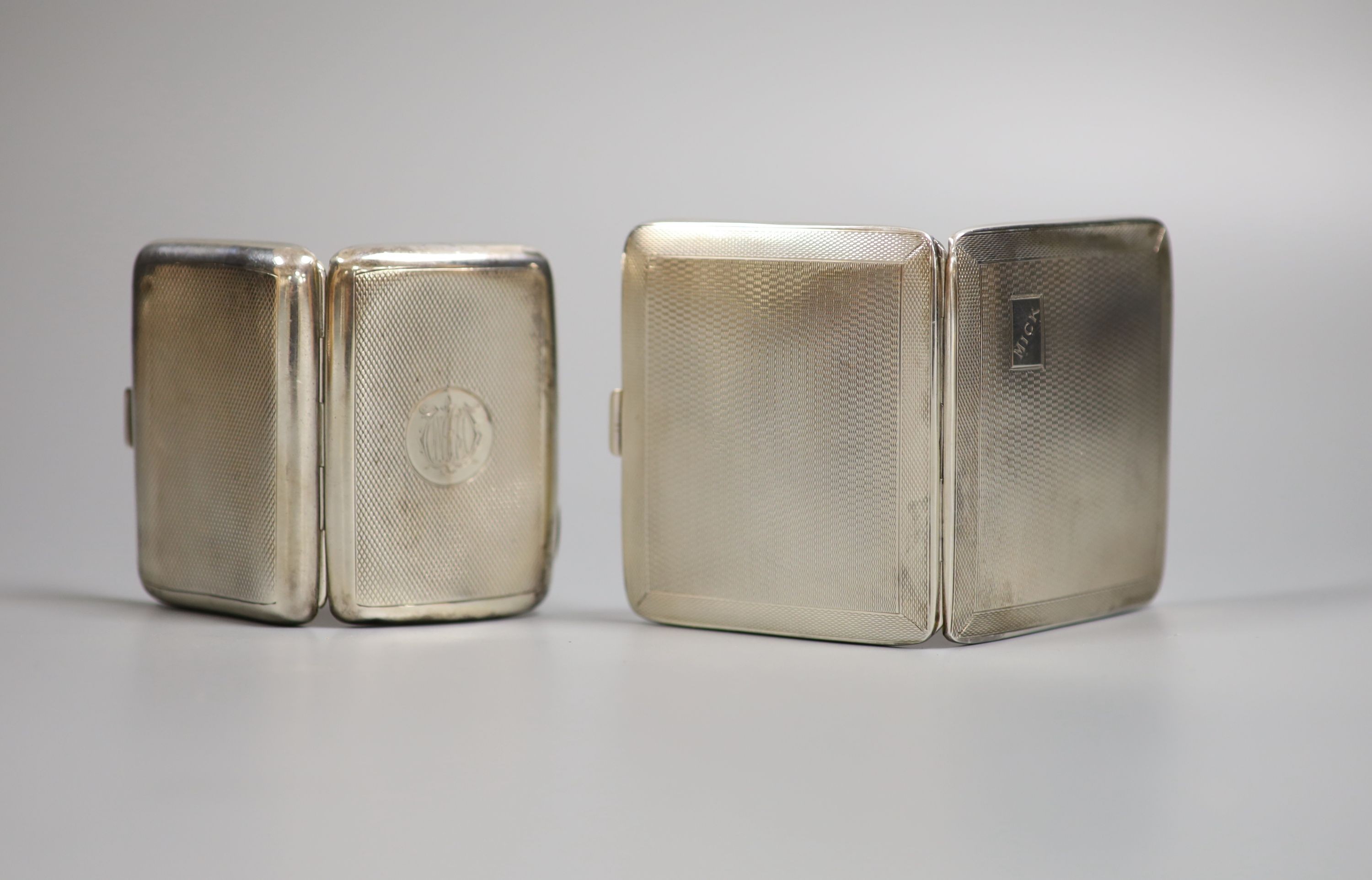 Two engine turned silver cigarette cases, including late Victorian, largest 86mm.